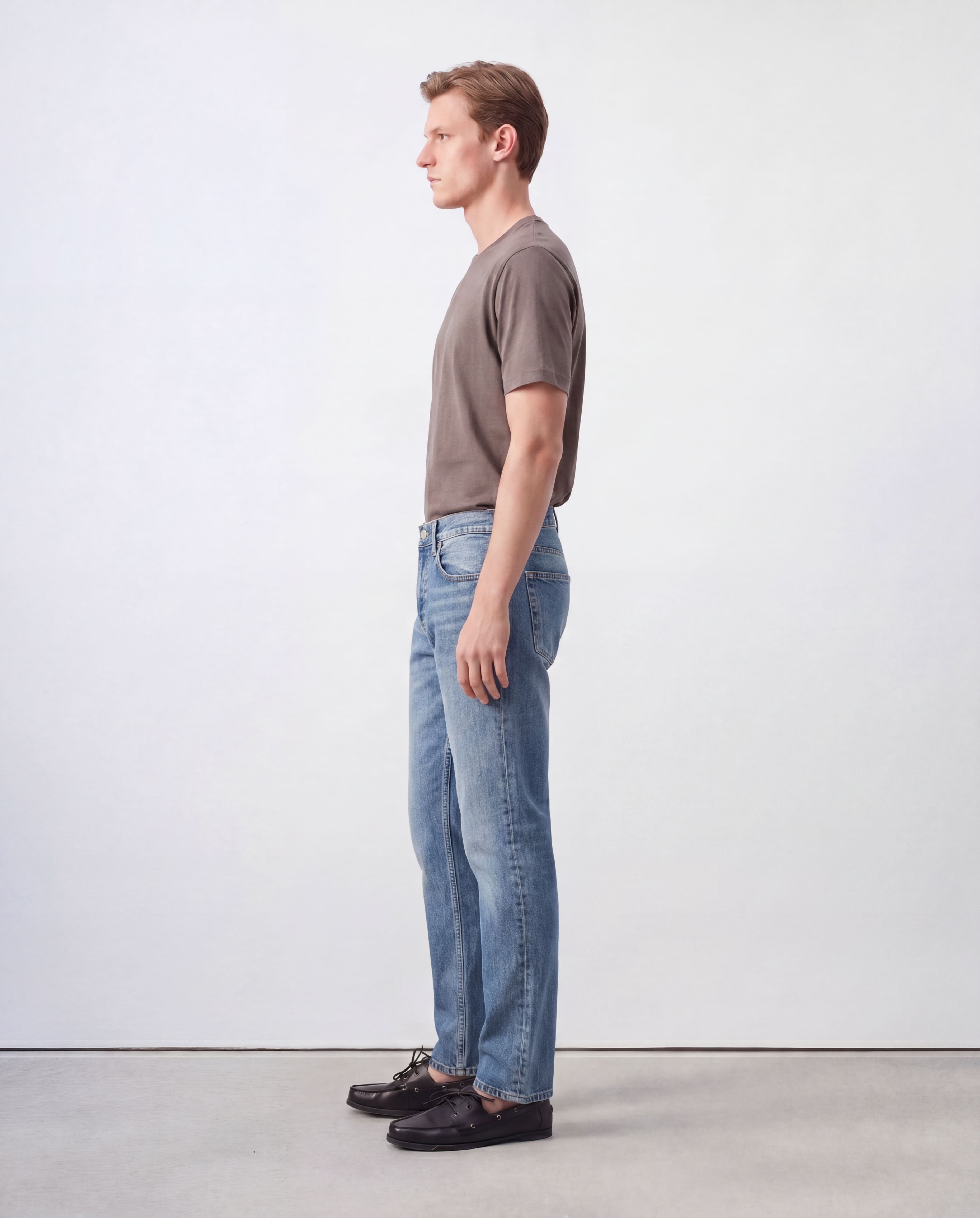Side profile view of model wearing Sama Denim men's light wash straight fit jeans