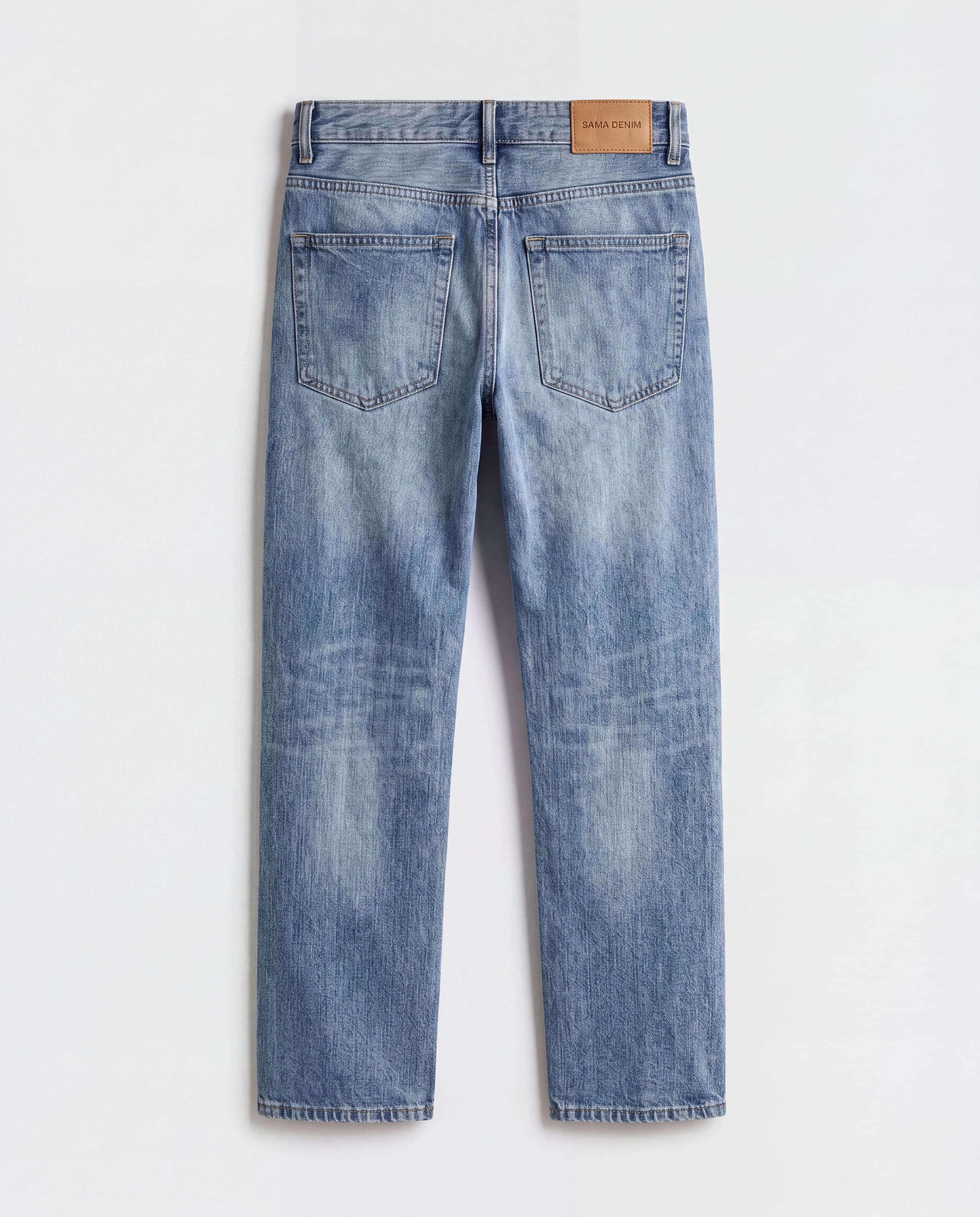 Back flat lay view of Sama Denim men's light wash straight fit jeans with signature leather patch