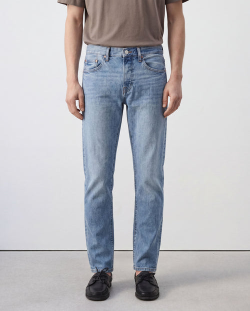 Front view of model wearing Sama Denim men's light wash straight fit jeans